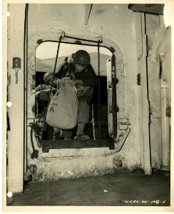 7th Division men entering the troop transport with their b…