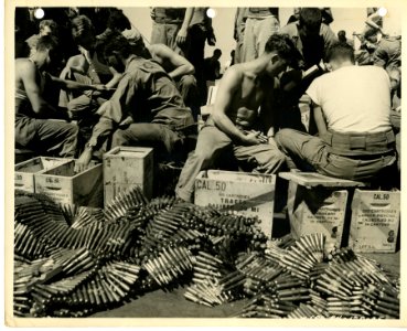 Men of the 7th Div., U.S. Army loading .50 cal. ammunition… photo