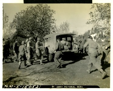 Men of an infantry division eagerly swarm toward the mail-… photo