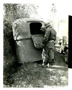 American soldiers examining the interior of a knocked out … photo