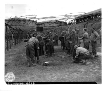 SC 190469 - Sullen-faced German POWs line up to be searche…