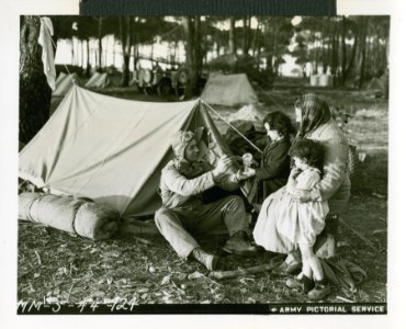 Sharing his rations with a homeless Italian family at his …