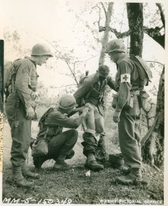 Sgt. Thomas Prudhomme, cleansing leg wound sustained durin… photo