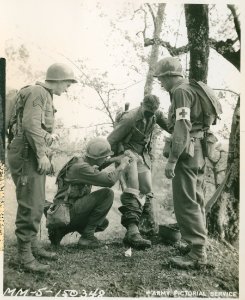 Sgt. Thomas Prudhomme, cleansing leg wound sustained durin…