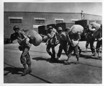 View of section of the 484th Port Bn. Marching up pier are…
