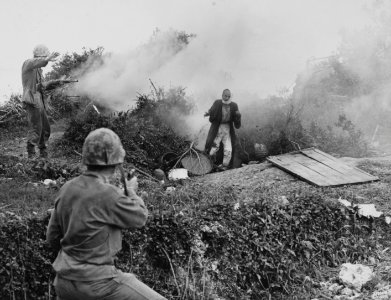 A Marine signals his comrade to hold fire as a Japanese ci…