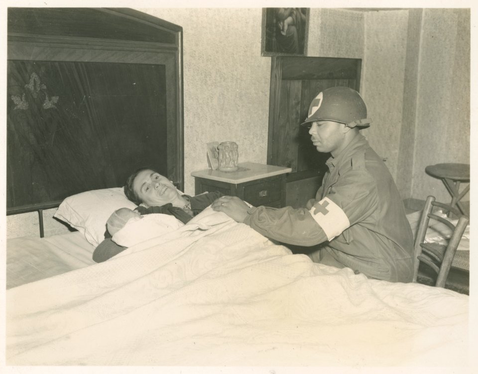 T/4 George McKenny with mother and baby which he delivered…