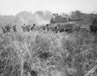 Marines advance with an M4 tank towards the airfield on Ca…