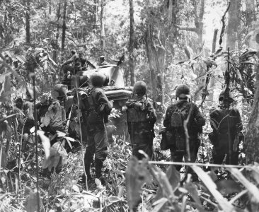 Marines advance with an M4 tank towards the airfield on Ca…