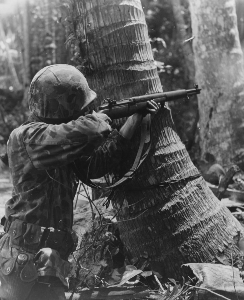 Marine Cpl William Coffron fires at Jap sniper from behind…