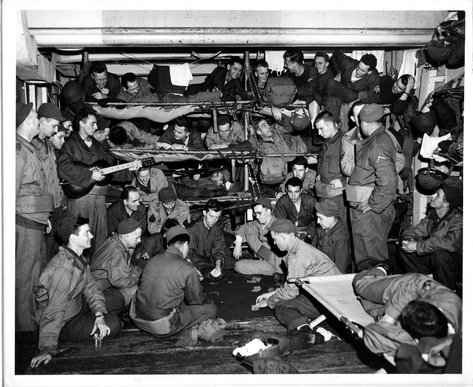 Soldiers aboard a Coast Guard-manned assault transport jam…