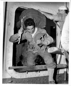American soldiers boarding a Coast Guard transport somewhe…