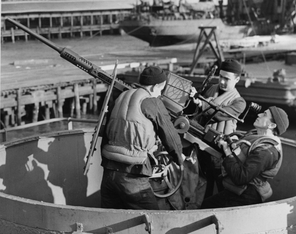 Sailors manning a 20mm anti-aircraft gun at Hampton Roads …