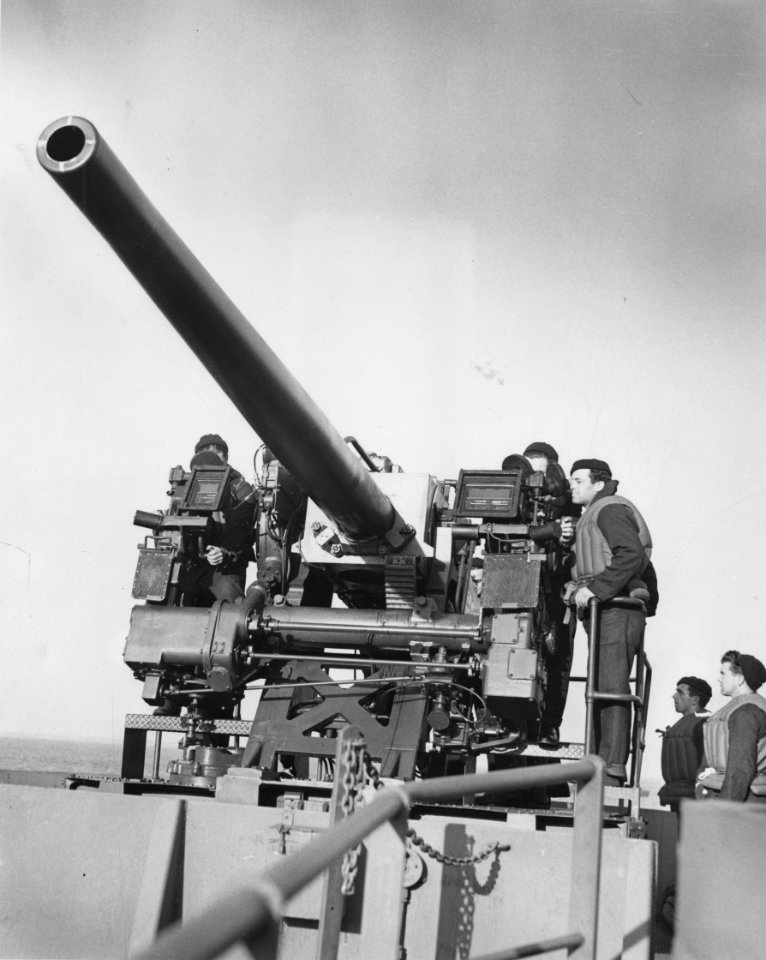 Sailors manning a 5 inch gun aboard SS Penelope Barker, at…
