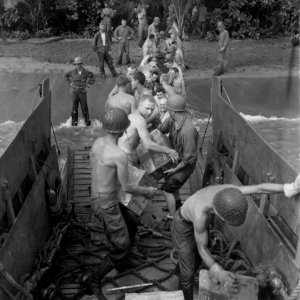 Beach party of 160th Inf, 40th Div, transfers small arms a…