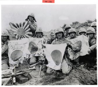 Fifth Division Marines hold up Japanese flags captured dur… photo