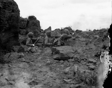 Three Marines in combat on Iwo Jima.