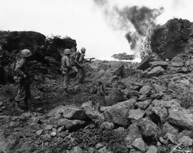 Marine flamethrower operator at work on Iwo Jima.