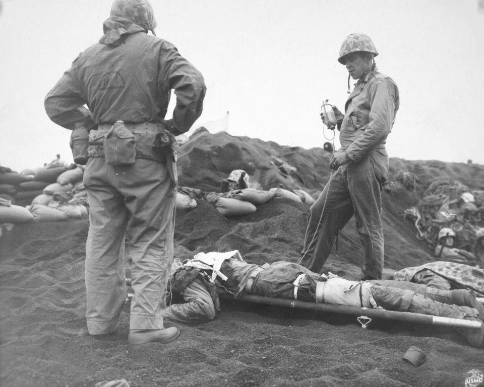 Arthur H. Clayton, a Navy corpsman on Iwo Jima, administer…