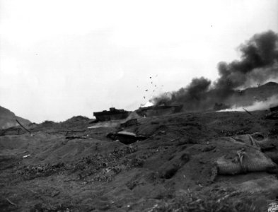 Two amphibious LVTs and a jeep, victims of Japanese mortar…