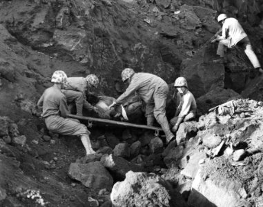 While the Marine at the right covers a cave entrance with …