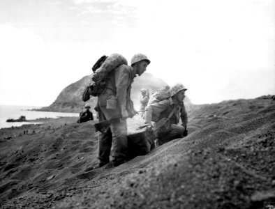 Marines prepare to move inland from the beach at Iwo Jima.…