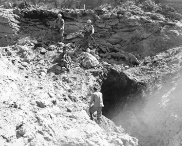 Two Marines stand guard as a Japanese prisoner tries to co… photo