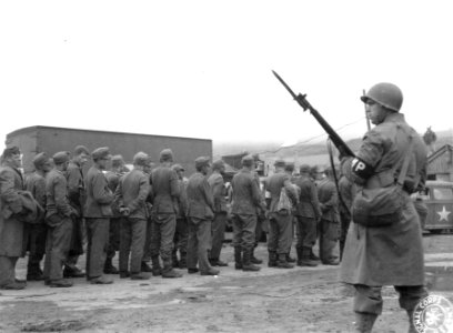 SC 190468 - A Military Policeman guards a long line of Ger…