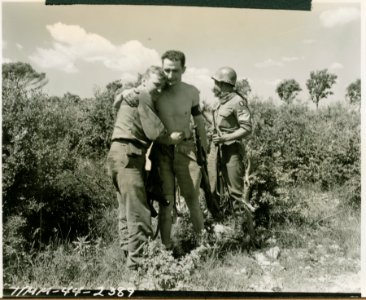 An armed partisan emotionally embraces 2nd Lt Jack Willis … photo