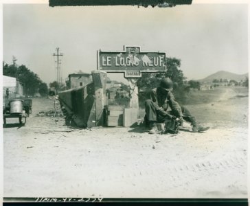 An American wire man does his work under the wrecked sign …