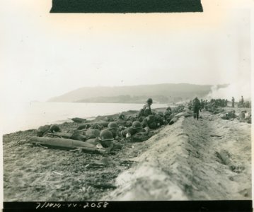 American medics and MPs of the 7th Army hugging the beach … photo