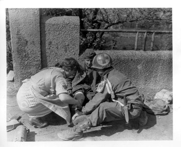 SC 370810 - German nurse assists an 8th Armored Division m… photo