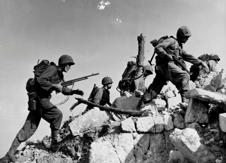 Equipped for any emergency, Marines hurdle a stone wall as…