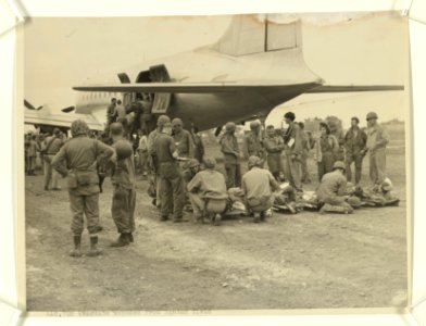 At the Jap Yontan airfield on Okinawa, wounded Marines are… photo