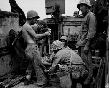Wounded Marine receives treatment aboard an LVT at Peleliu…
