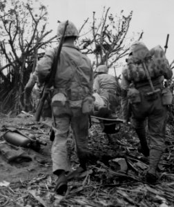 Fifth Division Marines on Iwo Jima carry a wounded comrade… photo