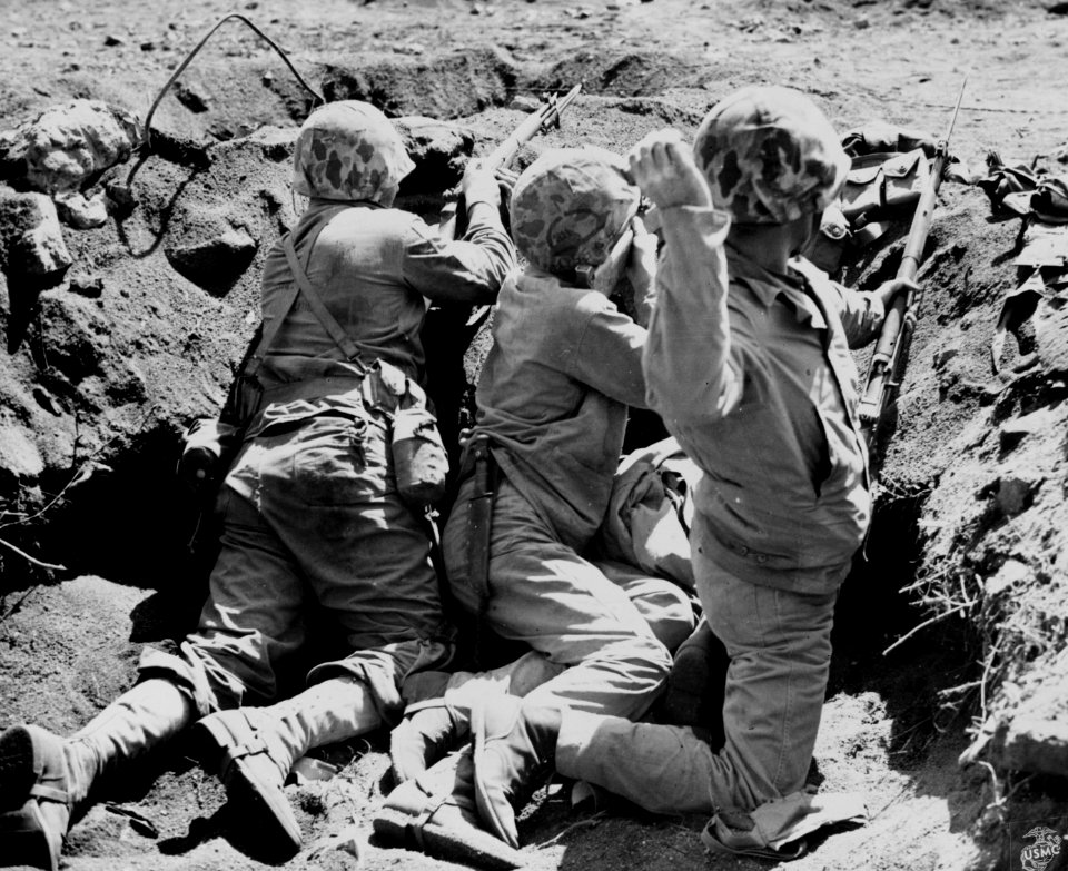 Three Marines of the 4th MARDIV in a foxhole on Iwo Jima.