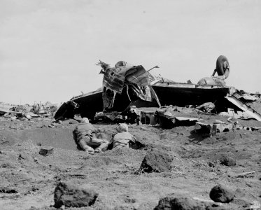 From a foxhole in the foreground, Marines fire at Japanese…