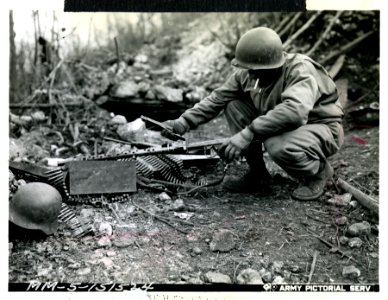 An American infantryman examines a captured German light m… photo