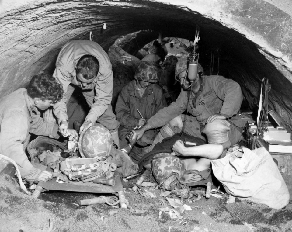 Marines, wounded in the battle for Iwo Jima, are sheltered…