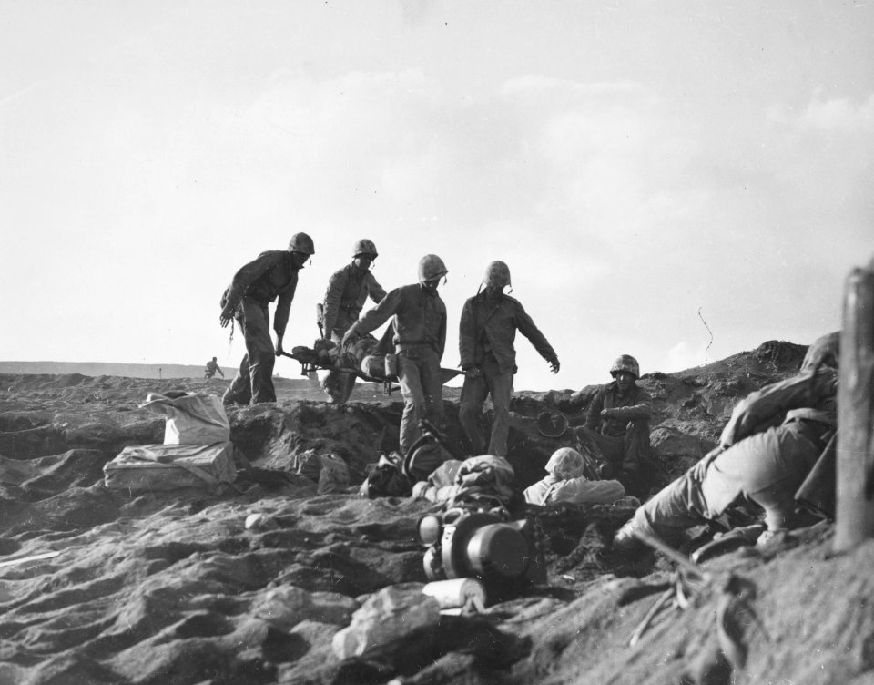 Ignoring the heavy enemy fire in the area, Marine stretche…