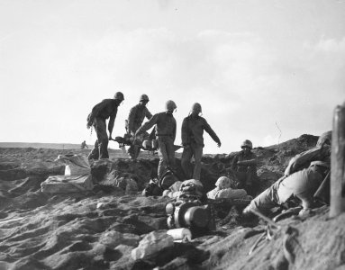 Ignoring the heavy enemy fire in the area, Marine stretche… photo