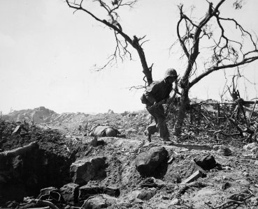 Marine moves forward past the body of a dead Japanese sold…