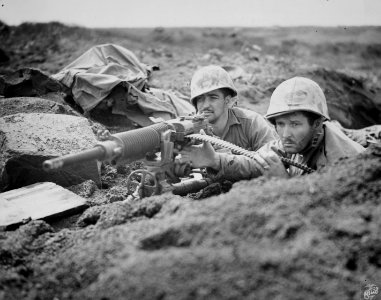 Two Marines operating a captured Japanese machine gun on I…