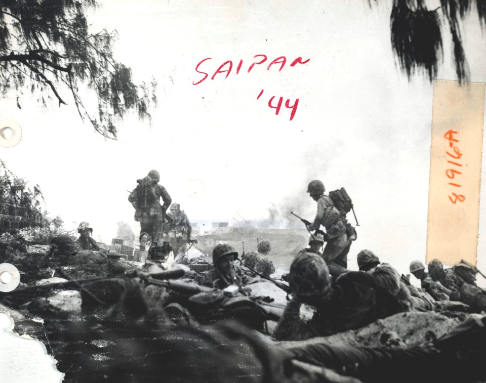 U.S. Marines dig in on the beach at Saipan in preparation …