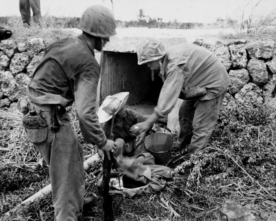 Marines attempt to question a civilian found in a dugout o…