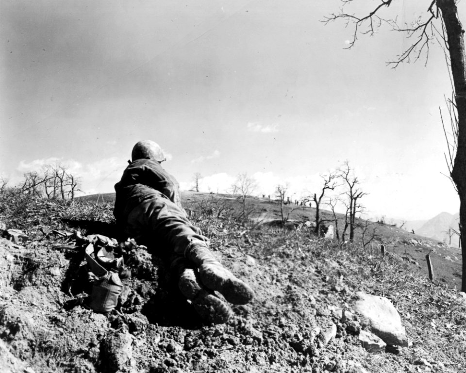 A 10th Mountain Division soldier watches from a distance a…