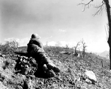 A 10th Mountain Division soldier watches from a distance a…
