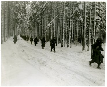 SC 199057-S - 75th Division Infantrymen move forward to ad… photo