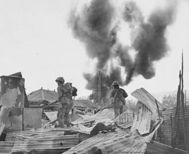 Marines enter the ruins of Garapan, principal city of Saip…